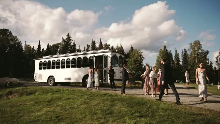 people getting on a trolley at a wedding